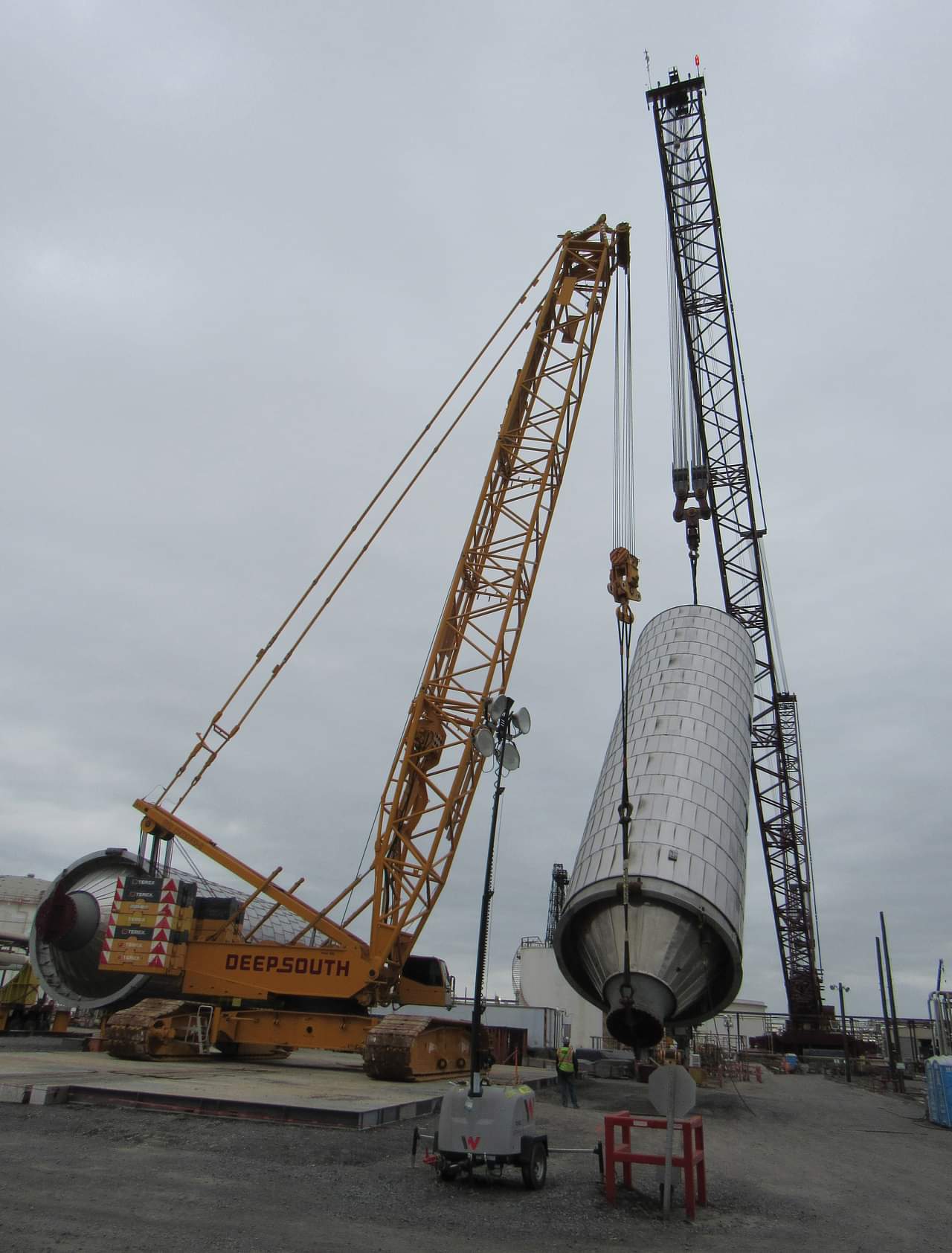 Crane lifting heavy coke drum