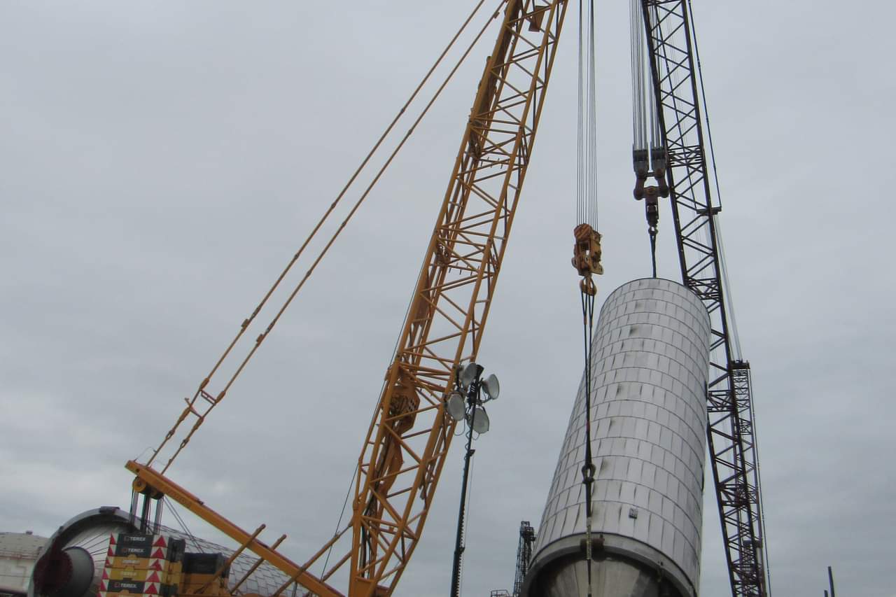 Crane lifting heavy coke drum